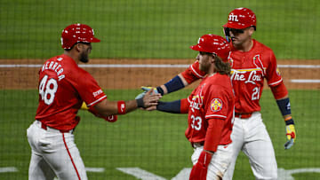 May 23, 2025; St. Louis, Missouri, USA;  St. Louis Cardinals designated hitter Ivan Herrera (48) right fielder Lars Nootbaar (21) and left fielder Brendan Donovan (33) celebrate after they scored on a three run triple by third baseman Nolan Arenado (not pictured) during the sixth inning against the Arizona Diamondbacks at Busch Stadium. Mandatory Credit: Jeff Curry-Imagn Images