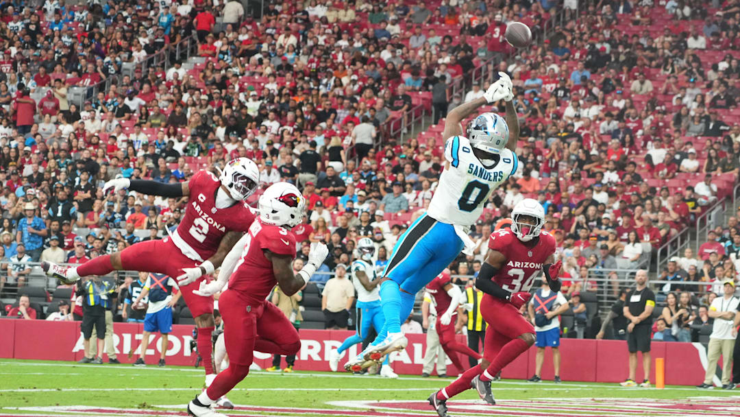 Sep 14, 2025; Glendale, Arizona, USA;  Carolina Panthers tight end Ja'Tavion Sanders (0) reaches for the ball during the fourth quarter against the Arizona Cardinals at State Farm Stadium. 