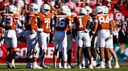 Texas Longhorns quarterback Arch Manning (16) huddles with his team during the game between the Texas Longhorns and the Oklahoma Sooners at the Cotton Bowl. 
