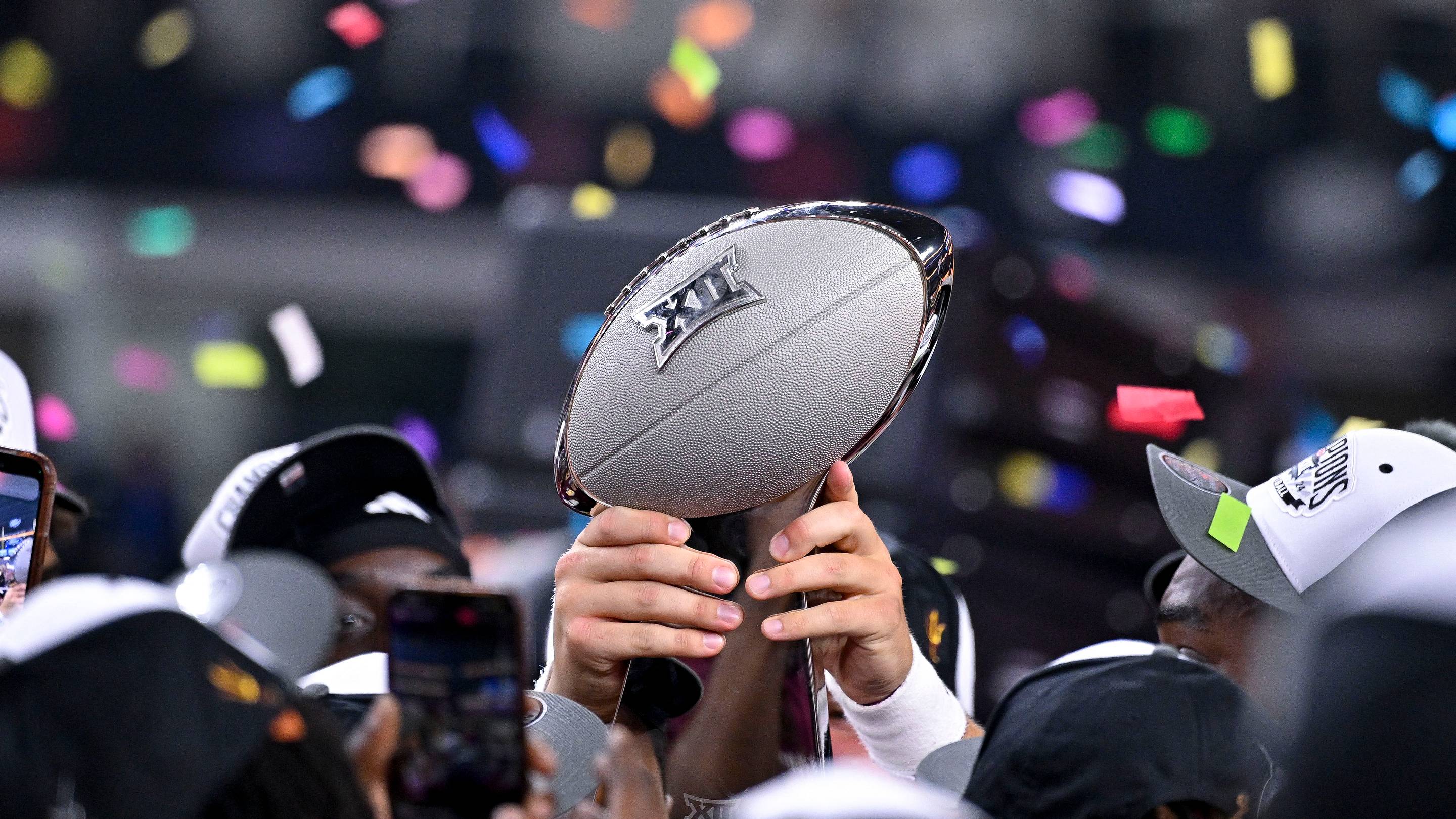 Dec 7, 2024; Arlington, TX, USA; The Arizona State Sun Devils team celebrate with the trophy after the Sun Devils defeat the Iowa State Cyclones and win the 2024 Big 12 Championship at AT&T Stadium. Mandatory Credit: Jerome Miron-Imagn Images