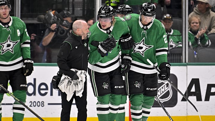Mar 6, 2026; Dallas, Texas, USA; Dallas Stars center Roope Hintz (24) is helped off the ice by left wing Jason Robertson (21) after being injured during the game between the Stars and the Avalanche at American Airlines Center. Mandatory Credit: Jerome Miron-Imagn Images