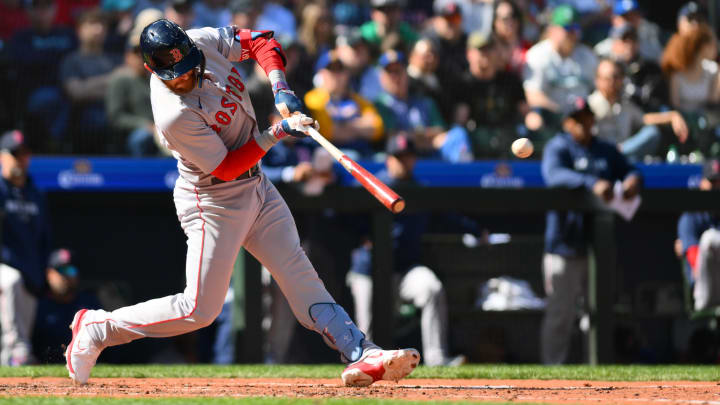 Mar 31, 2024; Seattle, Washington, USA; Boston Red Sox shortstop Trevor Story (10) hits a single against the Seattle Mariners during the seventh inning at T-Mobile Park. Mandatory Credit: Steven Bisig-USA TODAY Sports