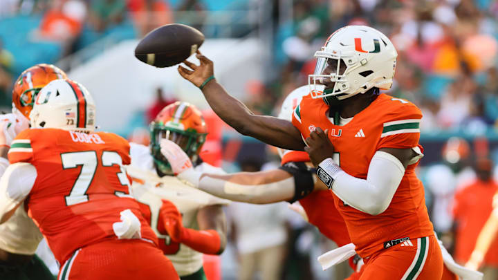 Sep 7, 2024; Miami Gardens, Florida, USA; Miami Hurricanes quarterback Cam Ward (1) passes the football against the Florida A&M Rattlers during the first quarter at Hard Rock Stadium. Mandatory Credit: Sam Navarro-Imagn Images