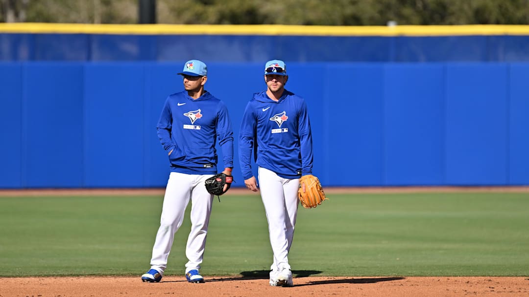 Feb 17, 2026; Dunedin, FL, USA;  Toronto Blue Jays infielder Andres Gimenez (0) and  infielder Ernie Clement (22) prepare  to take infield during spring training at Bobby Mattick Training Center at Englebert Complex. Mandatory Credit: Jonathan Dyer-Imagn Images