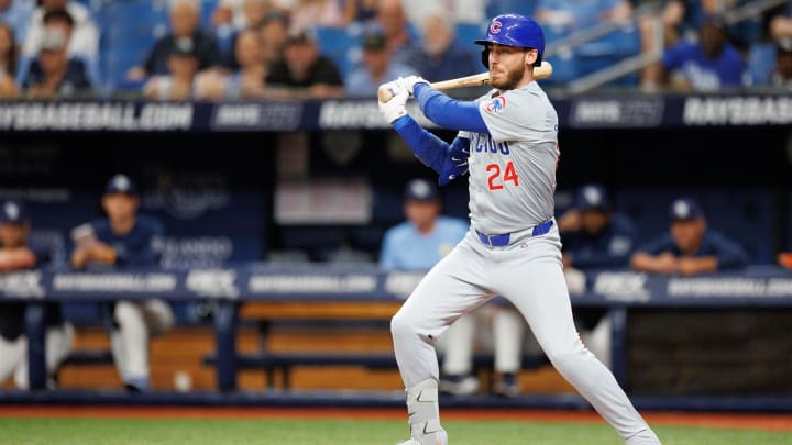 Jun 13, 2024; St. Petersburg, Florida, USA;  Chicago Cubs first baseman Cody Bellinger (24) hits a base hit against the Tampa Bay Rays in the first inning at Tropicana Field. 