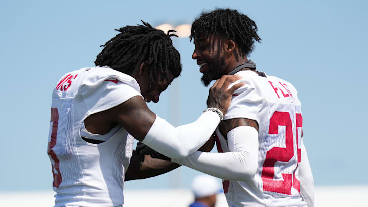 New York Giants cornerback Deonte Banks (3) and New York Giants cornerback Cordale Flott (28) laugh on the sideline during training camp at Quest Diagnostics Training Center.