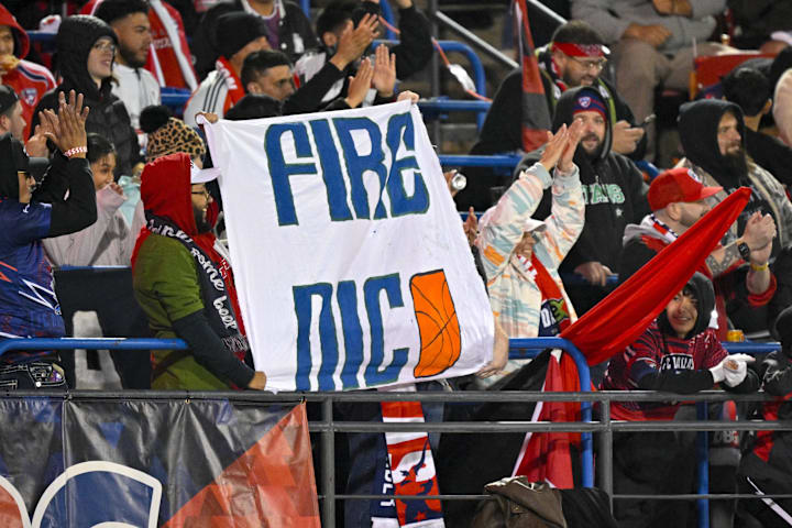 FC Dallas fans hold up a Fire Nico sign for Dallas Mavericks general manager Nico Harrison during the first half of the game 
