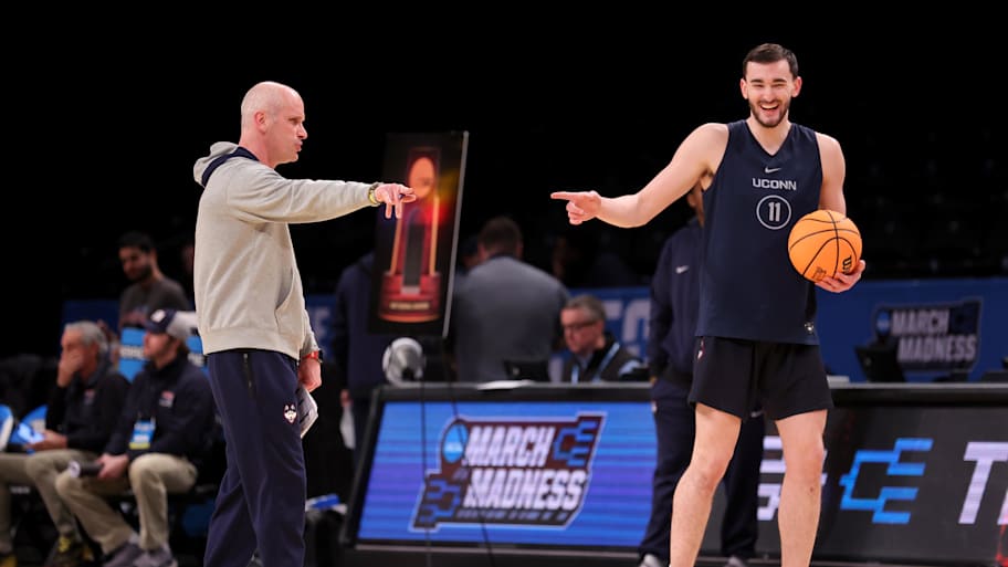 Dan Hurley and Alex Karaban joke during a March Madness practice in 2024.