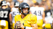 Aug 9, 2025; Iowa quarterback Mark Gronowski (11) runs a drill during the Hawkeyes Kids Day NCAA football open practice at Kinnick Stadium in Iowa City, Iowa. Mandatory Credit: Joseph Cress for the Des Moines Register