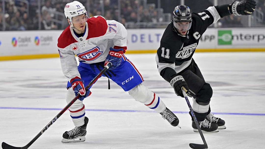 Feb 5, 2025; Los Angeles, California, USA;Montreal Canadiens center Jake Evans (71) and Los Angeles Kings center Anze Kopitar (11) chase down the puck in the second period at Crypto.com Arena. Mandatory Credit: Jayne Kamin-Oncea-Imagn Images