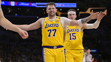 Feb 10, 2025; Los Angeles, California, USA; Los Angeles Lakers guard Luka Doncic (77) and guard Austin Reaves (15) react after a basket against the Utah Jazz at Crypto.com Arena. Mandatory Credit: Jayne Kamin-Oncea-Imagn Images