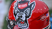 Nov 11, 2023; Winston-Salem, North Carolina, USA; The North Carolina State Wolfpack helmet rests on the bench during the second half against the Wake Forest Demon Deacons at Allegacy Federal Credit Union Stadium. Mandatory Credit: William Howard-Imagn Images