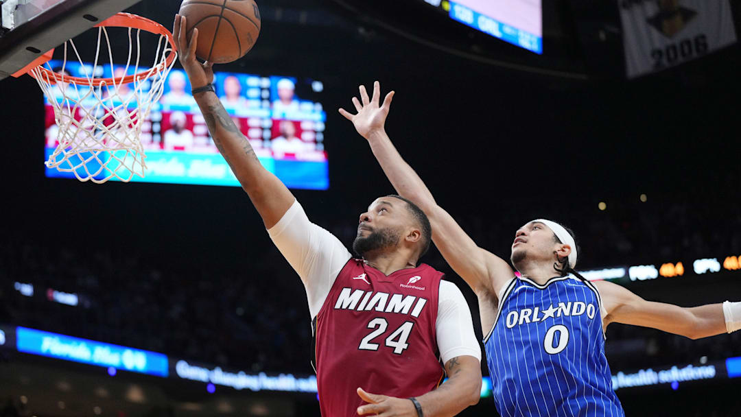 Jan 28, 2026; Miami, Florida, USA;  Miami Heat guard Norman Powell (24) goes up for a shot as Orlando Magic guard Anthony Black (0) follows on the play during the second half at Kaseya Center. Mandatory Credit: Jim Rassol-Imagn Images