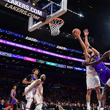 Jan 11, 2024; Los Angeles, California, USA; Los Angeles Lakers guard Skylar Mays (4) moves to the basket against Phoenix Suns center Bol Bol (11) during the second half at Crypto.com Arena. Mandatory Credit: Gary A. Vasquez-Imagn Images