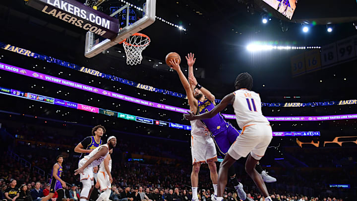 Jan 11, 2024; Los Angeles, California, USA; Los Angeles Lakers guard Skylar Mays (4) moves to the basket against Phoenix Suns center Bol Bol (11) during the second half at Crypto.com Arena. Mandatory Credit: Gary A. Vasquez-Imagn Images