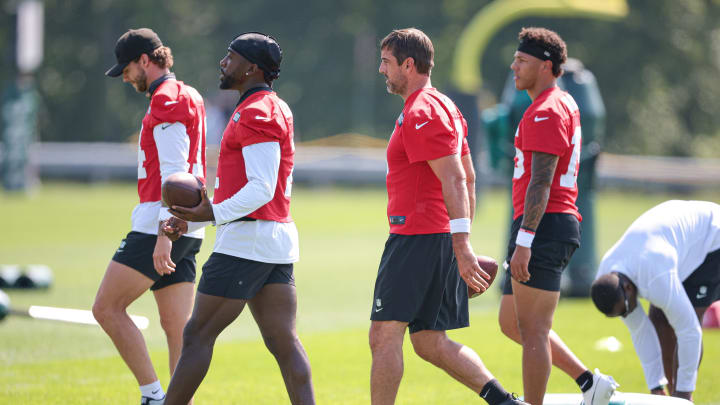 Jul 27, 2024; Florham Park, NJ, USA; New York Jets quarterback Aaron Rodgers (8) and quarterback Tyrod Taylor (2) walk across the field with teammates during training camp at Atlantic Health Jets Training Center.  