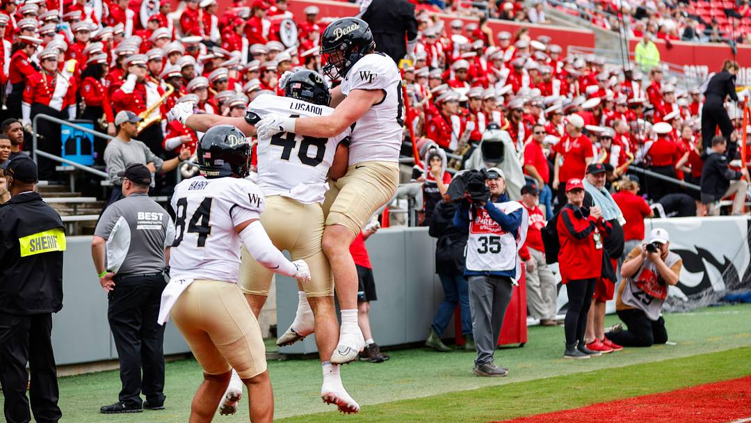 Oct 10, 2026; Raleigh, North Carolina, USA; Wake Forest Demon Deacons tight end Matthew Lusardi (48) celebrates his touchdown with tight end Dominick Barry (84) and defensive back Koredell Bartley (35) during the first half of the game against NC State Wolfpack at Carter-Finley Stadium. Mandatory Credit: Jaylynn Nash-Imagn Images Oct 10, 2026; Raleigh, North Carolina, USA; Wake Forest Demon Deacons tight end Matthew Lusardi (48) celebrates his touchdown with tight end Dominick Barry (84) and defensive back Koredell Bartley (35) during the first half of the game against NC State Wolfpack at Carter-Finley Stadium. Mandatory Credit: Jaylynn Nash-Imagn Images
