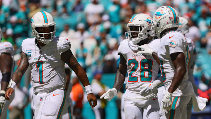 Sep 8, 2024; Miami Gardens, Florida, USA; Miami Dolphins running back De'Von Achane (28) celebrates with teammates after scoring a touchdown against the Jacksonville Jaguars during the second quarter at Hard Rock Stadium.