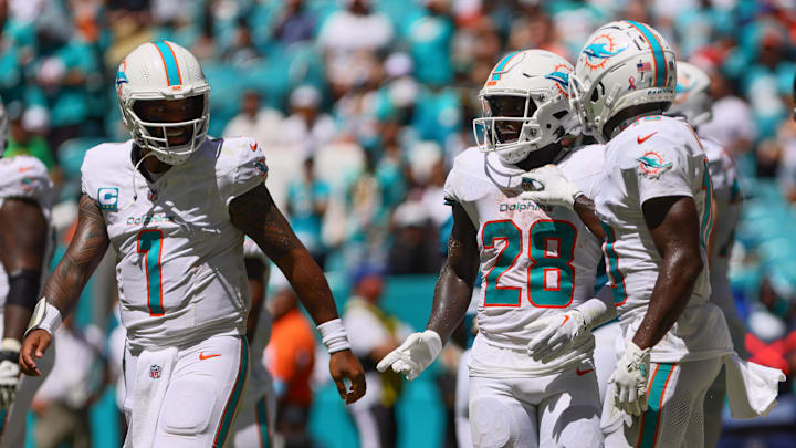 Miami Dolphins running back De'Von Achane (28) celebrates with teammates after scoring a touchdown against the Jacksonville Jaguars during the second quarter at Hard Rock Stadium. 