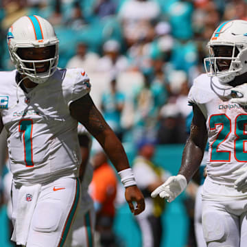 Miami Dolphins running back De'Von Achane (28) celebrates with teammates after scoring a touchdown against the Jacksonville Jaguars during the second quarter at Hard Rock Stadium. 