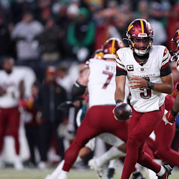 Washington Commanders quarterback Jayden Daniels hands off the ball to running back Brian Robinson Jr.