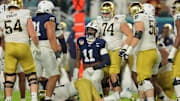 Jan 9, 2025; Miami, FL, USA; Penn State Nittany Lions defensive end Abdul Carter (11) celebrates a tackle on Notre Dame Fighting Irish quarterback Riley Leonard (13) in the first half in the Orange Bowl at Hard Rock Stadium.  