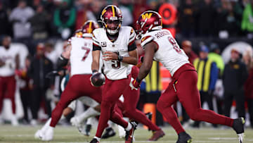 Washington Commanders quarterback Jayden Daniels hands off the ball to Brian Robinson Jr. against the Philadelphia Eagles