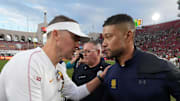 Nov 30, 2024; Los Angeles, California, USA; Southern California Trojans head coach Lincoln Riley and Notre Dame Fighting Irish head coach Marcus Freeman shake hands after the game at United Airlines Field at Los Angeles Memorial Coliseum. Mandatory Credit: Kirby Lee-Imagn Images