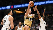 Nov 16, 2025; Washington, District of Columbia, USA;  Washington Wizards forward Corey Kispert (24) drives the to the basket between Brooklyn Nets forward Ziaire Williams (1) and forward Michael Porter Jr. (17) during the third quarter at Capital One Arena. Mandatory Credit: Rafael Suanes-Imagn Images