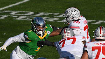 Jan 1, 2025; Pasadena, CA, USA; Oregon Ducks defensive end Jordan Burch (1) is blocked by Ohio State Buckeyes offensive lineman Tegra Tshabola (77) and Josh Fryar (70) during the first quarter at Rose Bowl Stadium. Mandatory Credit: Robert Hanashiro-Imagn Images