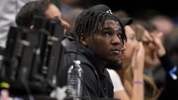 Feb 12, 2025; Dallas, Texas, USA; Miami Hurricanes Quarterback Cam Ward watches the game between the Dallas Mavericks and the Golden State Warriors during the second half at the American Airlines Center. Mandatory Credit: Jerome Miron-Imagn Images