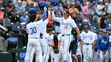 Jun 19, 2024; Omaha, NE, USA;  Florida Gators designated hitter Brody Donay (29) celebrates hitting a grand slam with right fielder Ashton Wilson (30) Mandatory Credit: Steven Branscombe-Imagn Images