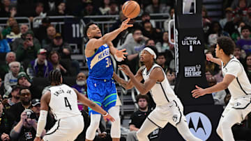 Mar 21, 2024; Milwaukee, Wisconsin, USA;  Milwaukee Bucks forward Giannis Antetokounmpo (34) gets a pass away from Brooklyn Nets center Nicolas Claxton (33) and guard Dennis Smith Jr. (4) in the fourth quarterat Fiserv Forum. Mandatory Credit: Benny Sieu-Imagn Images