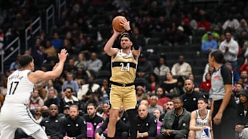 Nov 16, 2025; Washington, District of Columbia, USA;  Washington Wizards forward Corey Kispert (24) attempts a jump shot in front of Brooklyn Nets forward Michael Porter Jr. (17) during the third quarter at Capital One Arena. Mandatory Credit: Rafael Suanes-Imagn Images