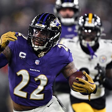Jan 11, 2025; Baltimore, Maryland, USA; Baltimore Ravens running back Derrick Henry (22) runs against Pittsburgh Steelers linebacker Elandon Roberts (50) in the second quarter in an AFC wild card game at M&T Bank Stadium. Mandatory Credit: Tommy Gilligan-Imagn Images