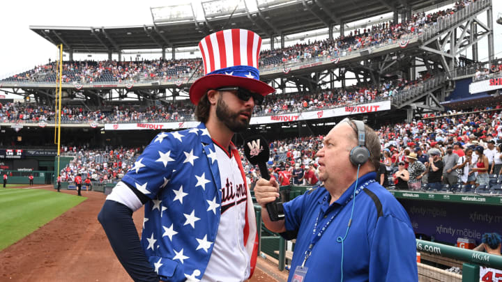 Washington Nationals left fielder Jesse Winker (6) gets interviewed by Craig Heist while wearing a patriotic themed top hat after the game against the New York Mets at Nationals Park on July 4.