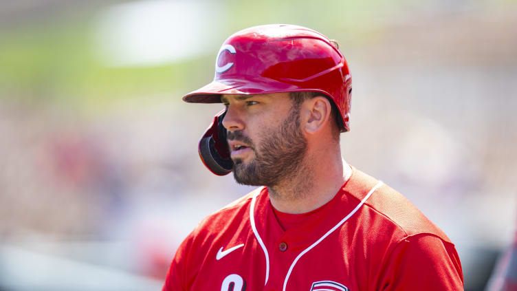 Cincinnati Reds infielder Mike Moustakas looks on.