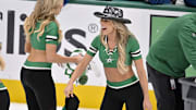 The Dallas Stars ice girls pick up hats off the ice after Mikko Rantanen scores a hat trick against the Colorado Avalanche.