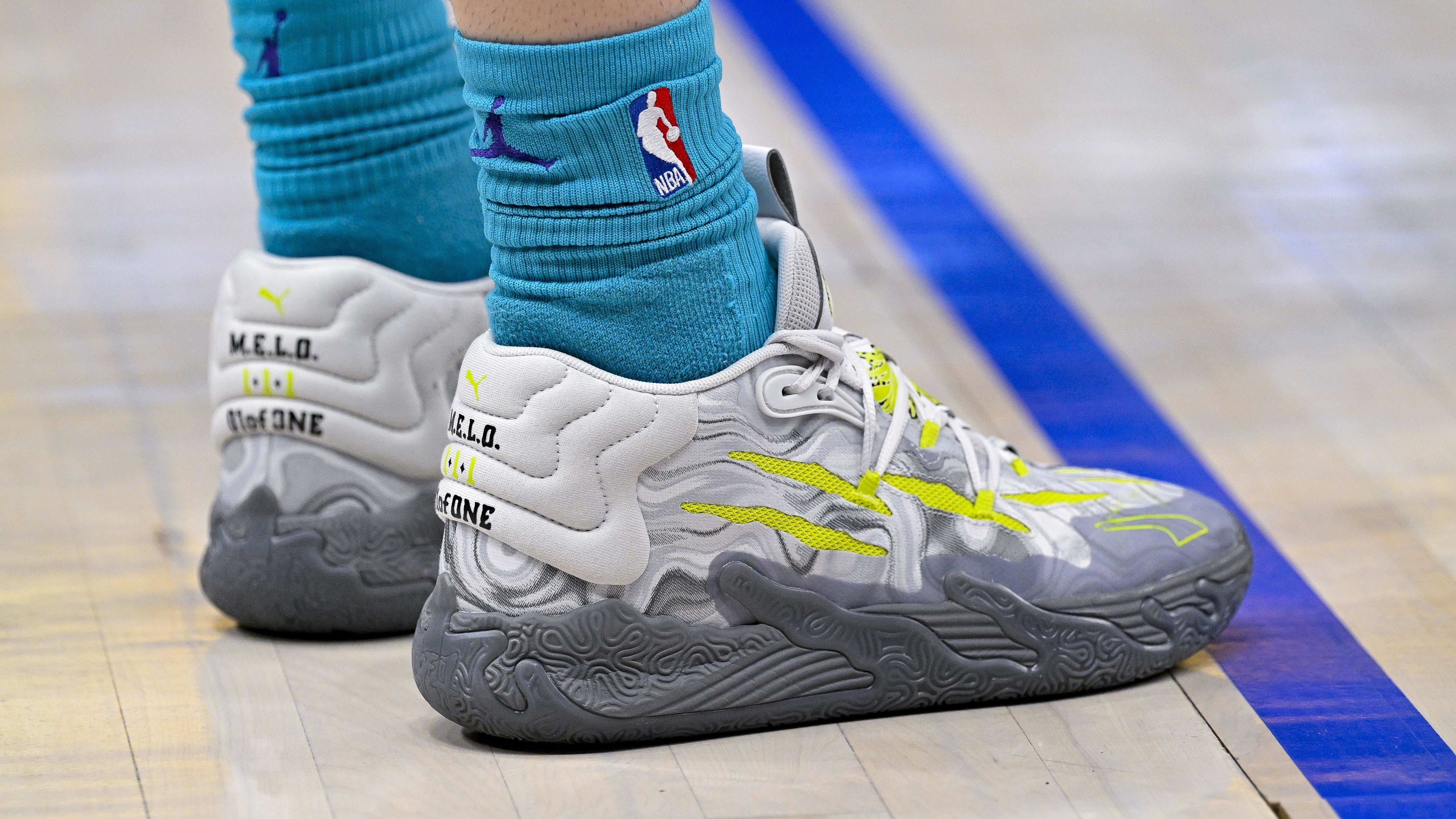 Charlotte Hornets guard LaMelo Ball's grey and green PUMA sneakers.