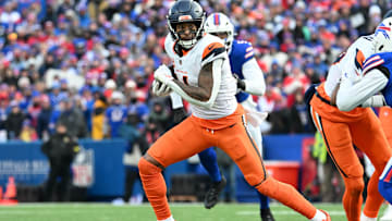 Jan 12, 2025; Orchard Park, New York, USA; Denver Broncos wide receiver Courtland Sutton (14) runs after making a catch in the fourth quarter of an AFC wild card game against the Buffalo Bills at Highmark Stadium. Mandatory Credit: Mark Konezny-Imagn Images