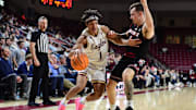 Feb 5, 2025; Chestnut Hill, Massachusetts, USA; Boston College Eagles guard Dion Brown (1) controls the ball while Louisville Cardinals guard Reyne Smith (6) defends during the second half at Conte Forum. Mandatory Credit: Bob DeChiara-Imagn Images