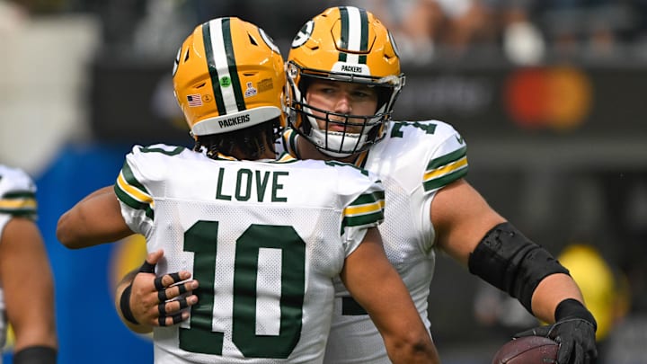 Green Bay Packers quarterback Jordan Love (10) hugs center Josh Myers (71) before an NFL game against the Los Angeles Rams at SoFi Stadium.