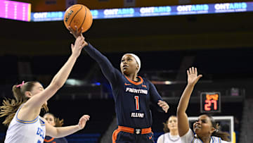 Feb 20, 2025; Los Angeles, California, USA;  Illinois Fighting Illini guard Genesis Bryant (1) drives to the basket between UCLA Bruins guards Elina Aarnisalo (7) and Londynn Jones (3) during the first quarter at Pauley Pavilion presented by Wescom. Mandatory Credit: Robert Hanashiro-Imagn Images
