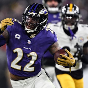 Jan 11, 2025; Baltimore, Maryland, USA; Baltimore Ravens running back Derrick Henry (22) runs against Pittsburgh Steelers linebacker Elandon Roberts (50) in the second quarter in an AFC wild card game at M&T Bank Stadium. Mandatory Credit: Tommy Gilligan-Imagn Images