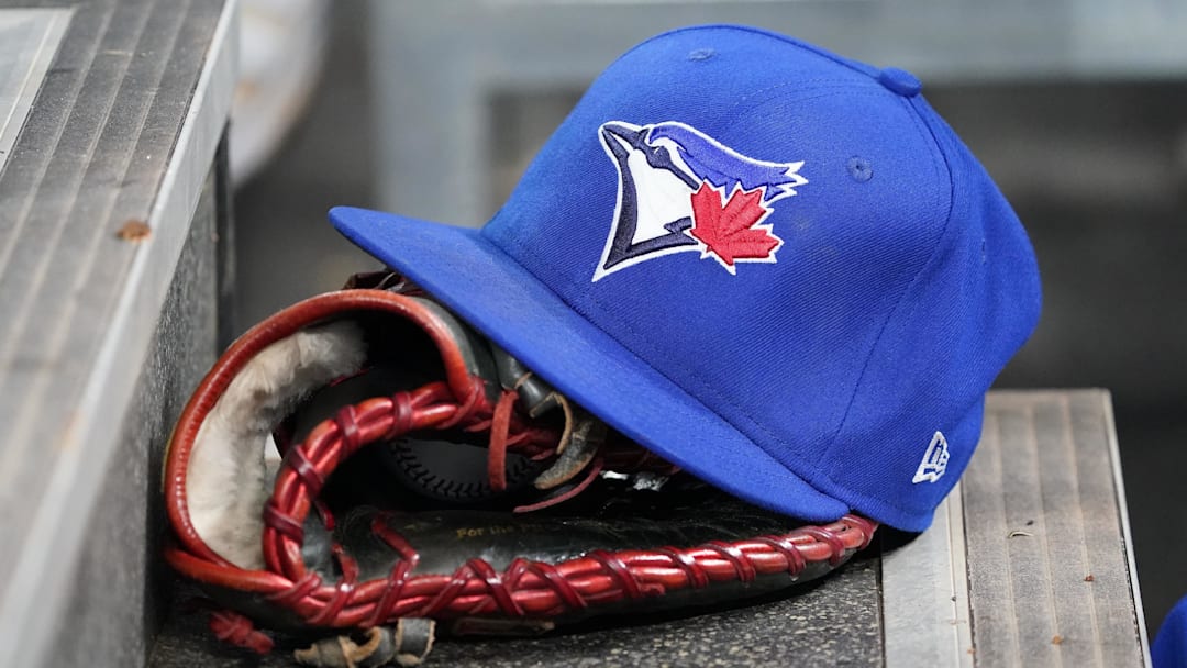 Apr 16, 2025; Toronto, Ontario, CAN; A Toronto Blue Jays hat and glove in the dugout during a game against the Atlanta Braves at Rogers Centre. 