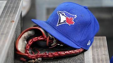 A Toronto Blue Jays hat and glove in the dugout during a game against the Atlanta Braves at Rogers Centre. 
