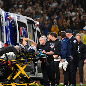 May 12, 2025; Seattle, Washington, USA; New York Yankees third baseman Oswaldo Cabrera (95) is loaded into an ambulance after a leg injury while scoring a run against the Seattle Mariners during the eighth inning at T-Mobile Park.