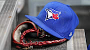 Apr 16, 2025; Toronto, Ontario, CAN; A Toronto Blue Jays hat and glove in the dugout during a game against the Atlanta Braves at Rogers Centre.