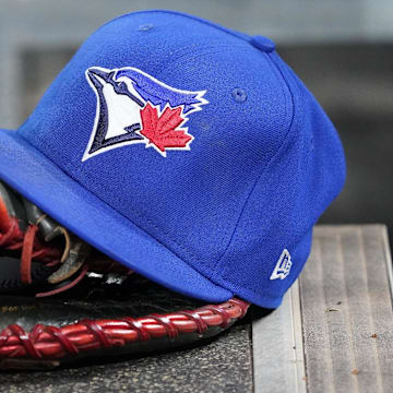 Apr 16, 2025; Toronto, Ontario, CAN; A Toronto Blue Jays hat and glove in the dugout during a game against the Atlanta Braves at Rogers Centre. 