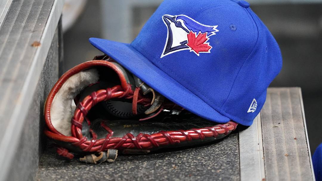 Apr 16, 2025; Toronto, Ontario, CAN; A Toronto Blue Jays hat and glove in the dugout during a game against the Atlanta Braves at Rogers Centre.